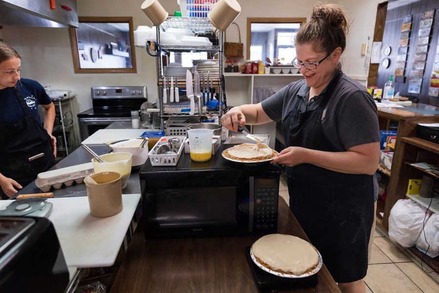 Baker preparing pies in small town cafe