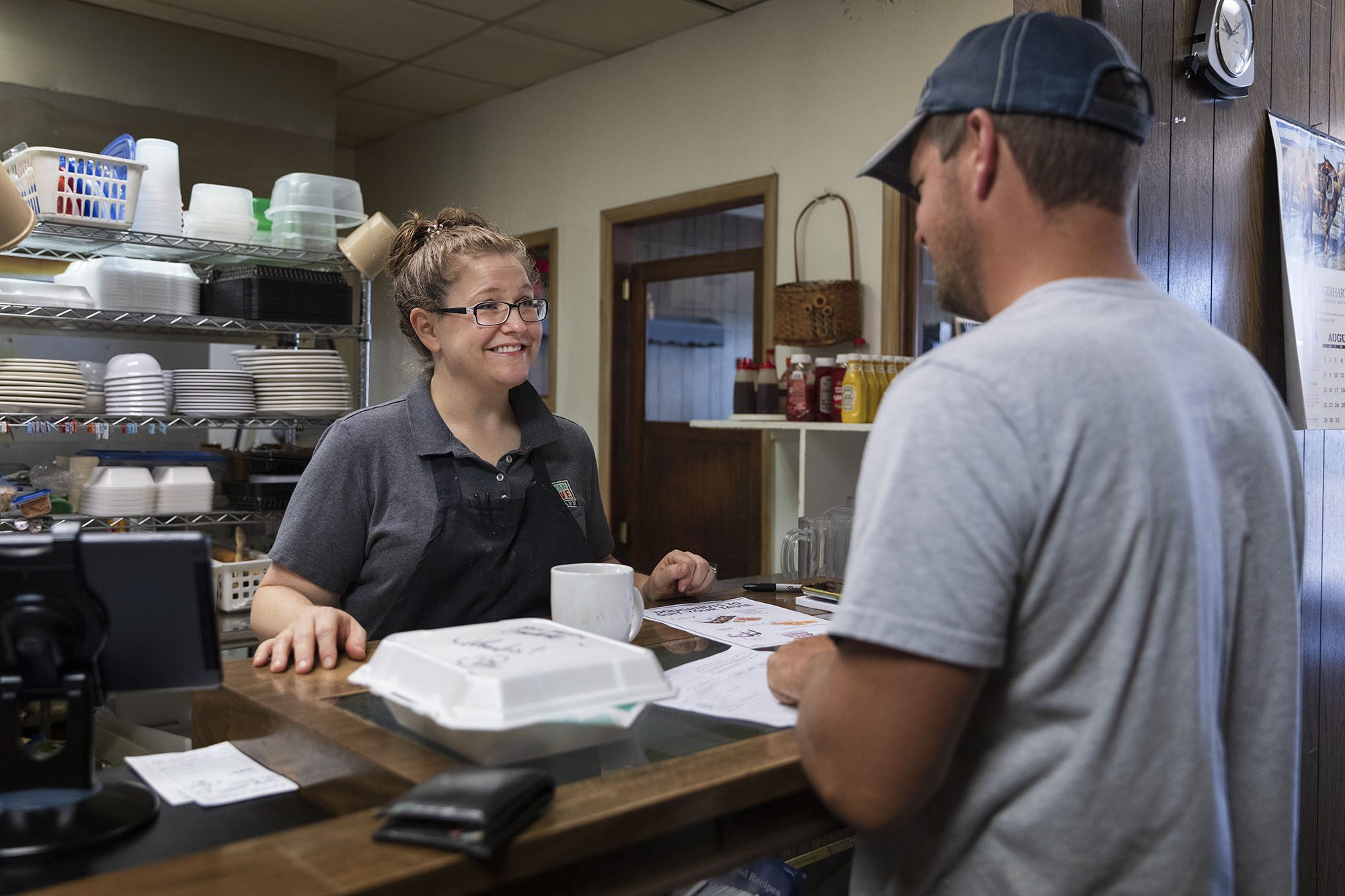 Local cafe owner serving customer